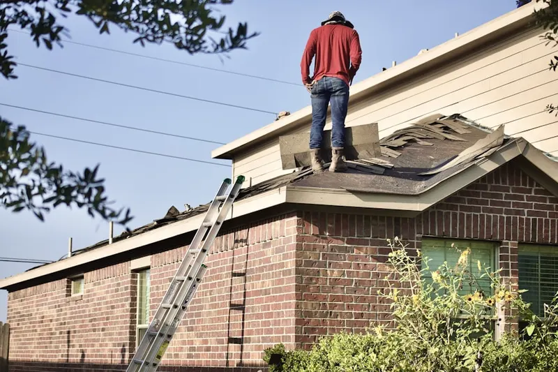Professional roofer working on a residential roof in Burley